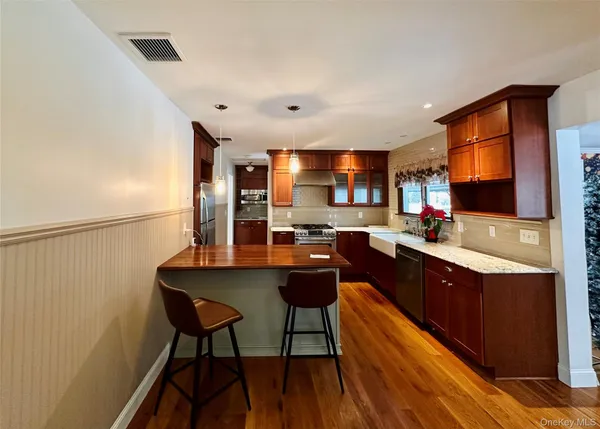 a kitchen with stainless steel appliances granite countertop a sink counter space and cabinets