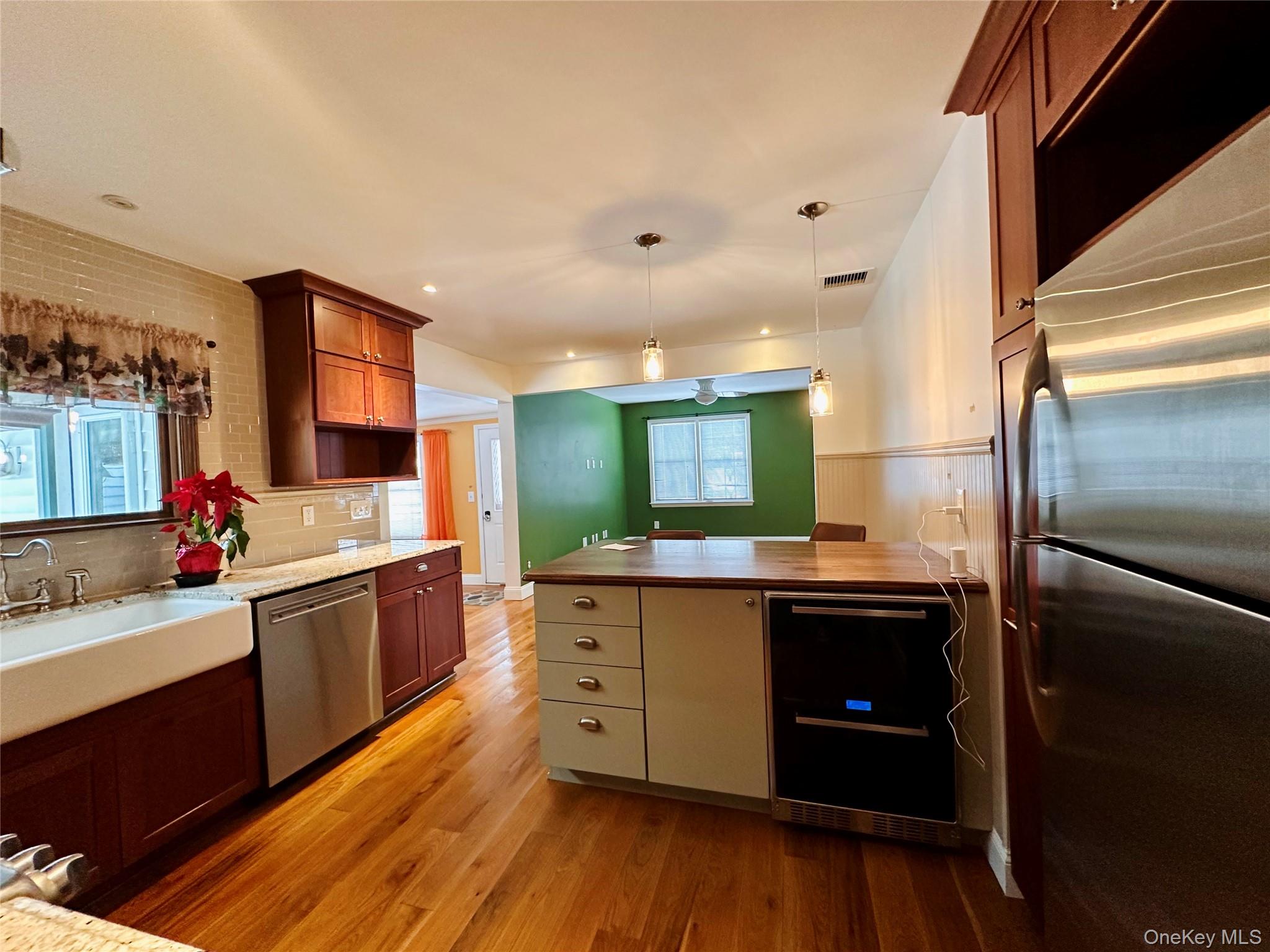3191 Highway 9, Unit 2 Cold Spring, NY 10516 - Photo 5 of 16 a kitchen with stainless steel appliances granite countertop a sink cabinets and wooden floor