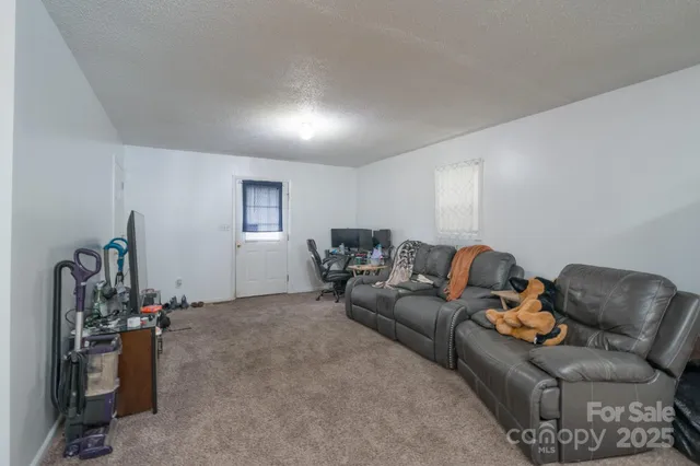 a living room with furniture a window and gym equipment