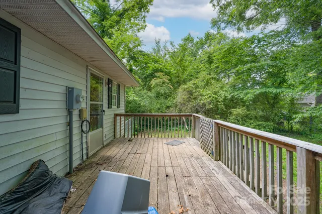a balcony with wooden floor in front of it