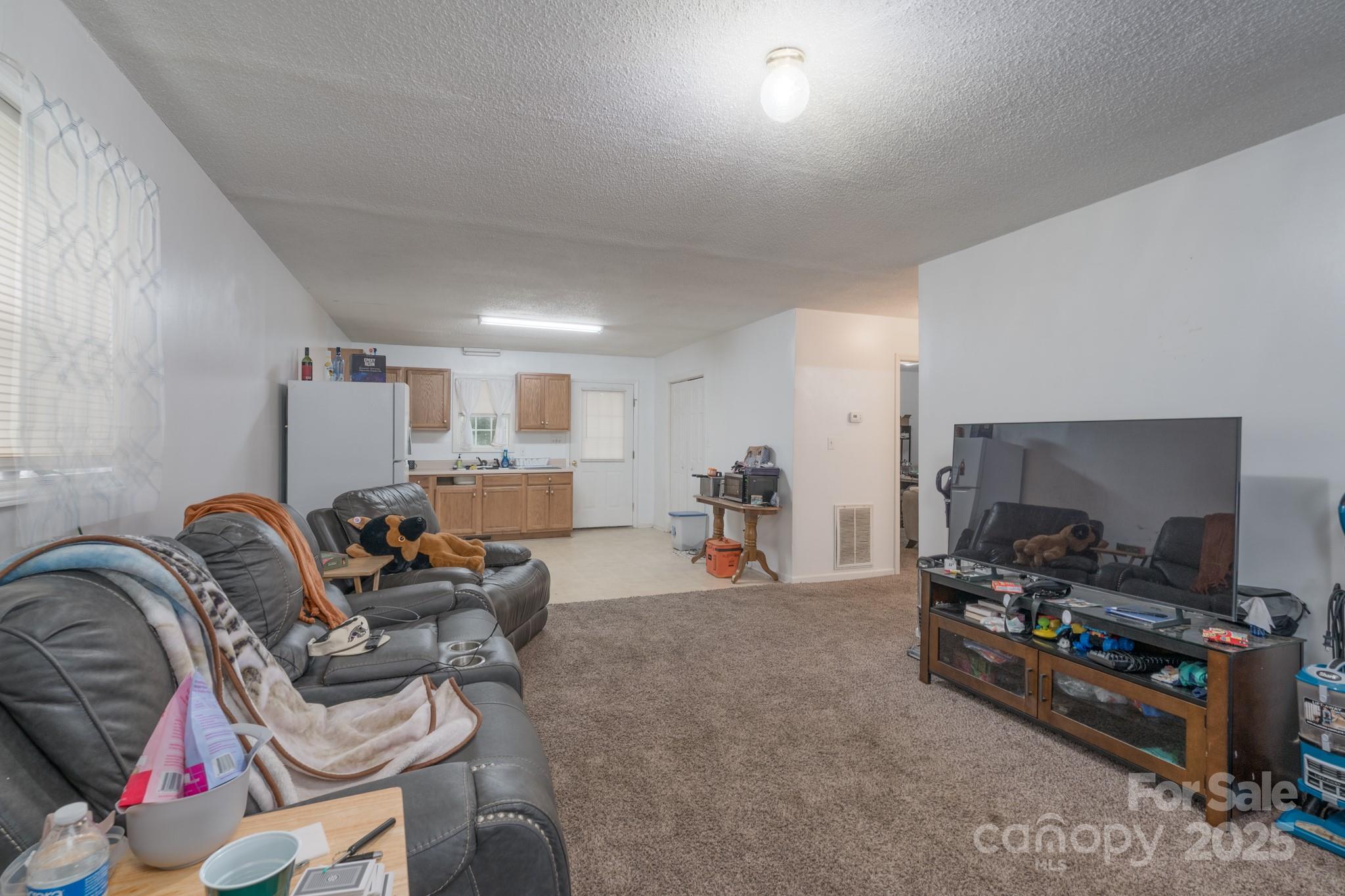 5624 Pleasant Avenue, Unit 3 Fort Lawn, SC 29714 - Photo 10 of 24 a living room with furniture a flat screen tv and gym equipment