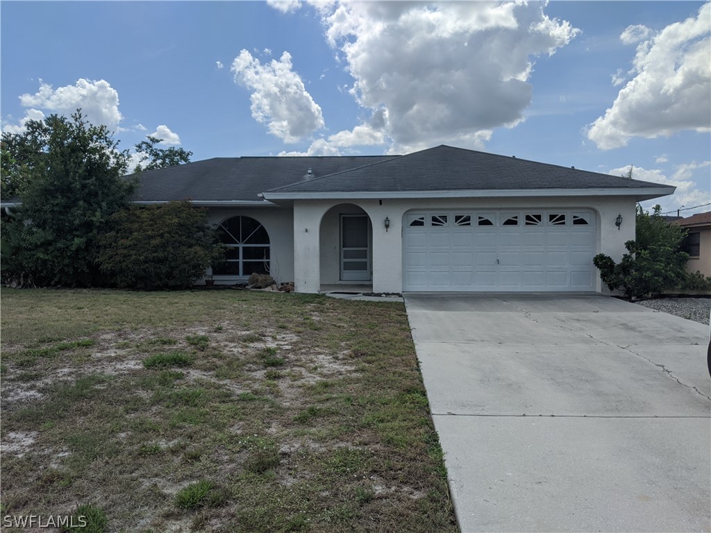 17496 Fuchsia Road Fort Myers, FL 33967 - Photo 1 of 9 a front view of a house with a yard