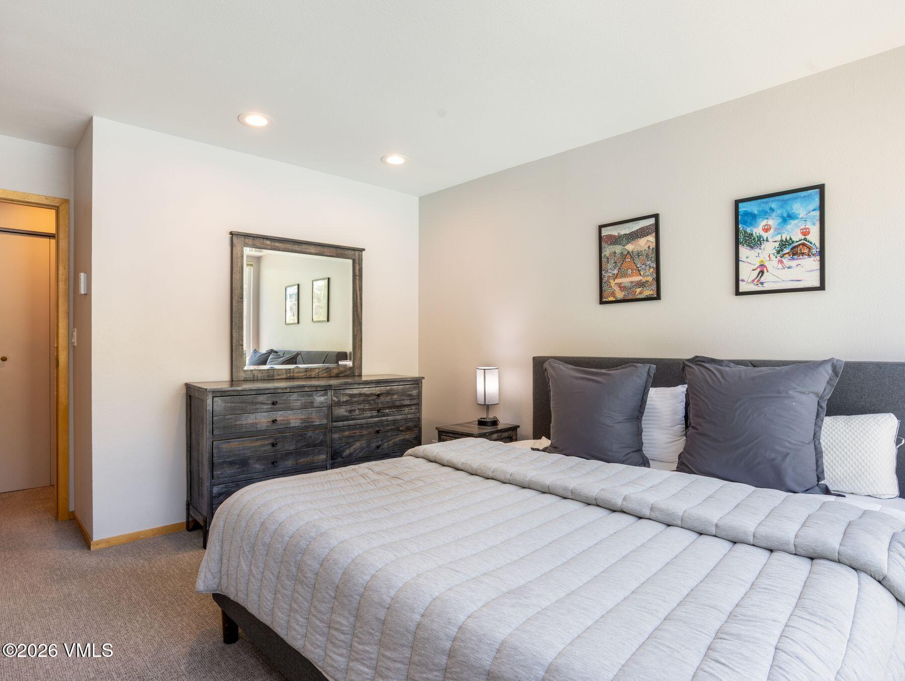 1100 North Frontage Road West, Unit 1503 Vail, CO 81657 - Photo 17 of 32 a bedroom with a bed and a dresser