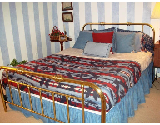 63 Garden Road, Unit G5 Wellesley, MA 02481 - Photo 15 of 19 a bedroom with a bed and a painting on the wall