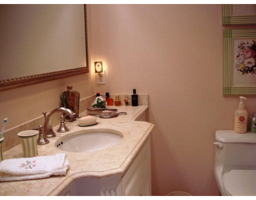 63 Garden Road, Unit G5 Wellesley, MA 02481 - Photo 18 of 19 a bathroom with a sink and a mirror