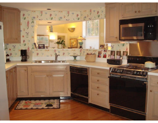 63 Garden Road, Unit G5 Wellesley, MA 02481 - Photo 3 of 19 a kitchen with a stove a sink and a microwave