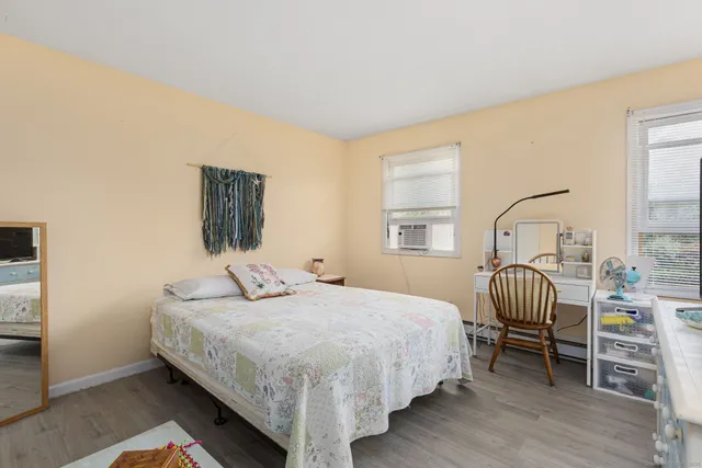 a bedroom with a bed chairs and a window