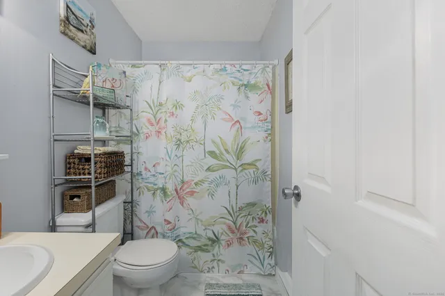 a bathroom with a toilet and shower