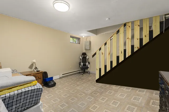 a view of a livingroom with furniture and stairs