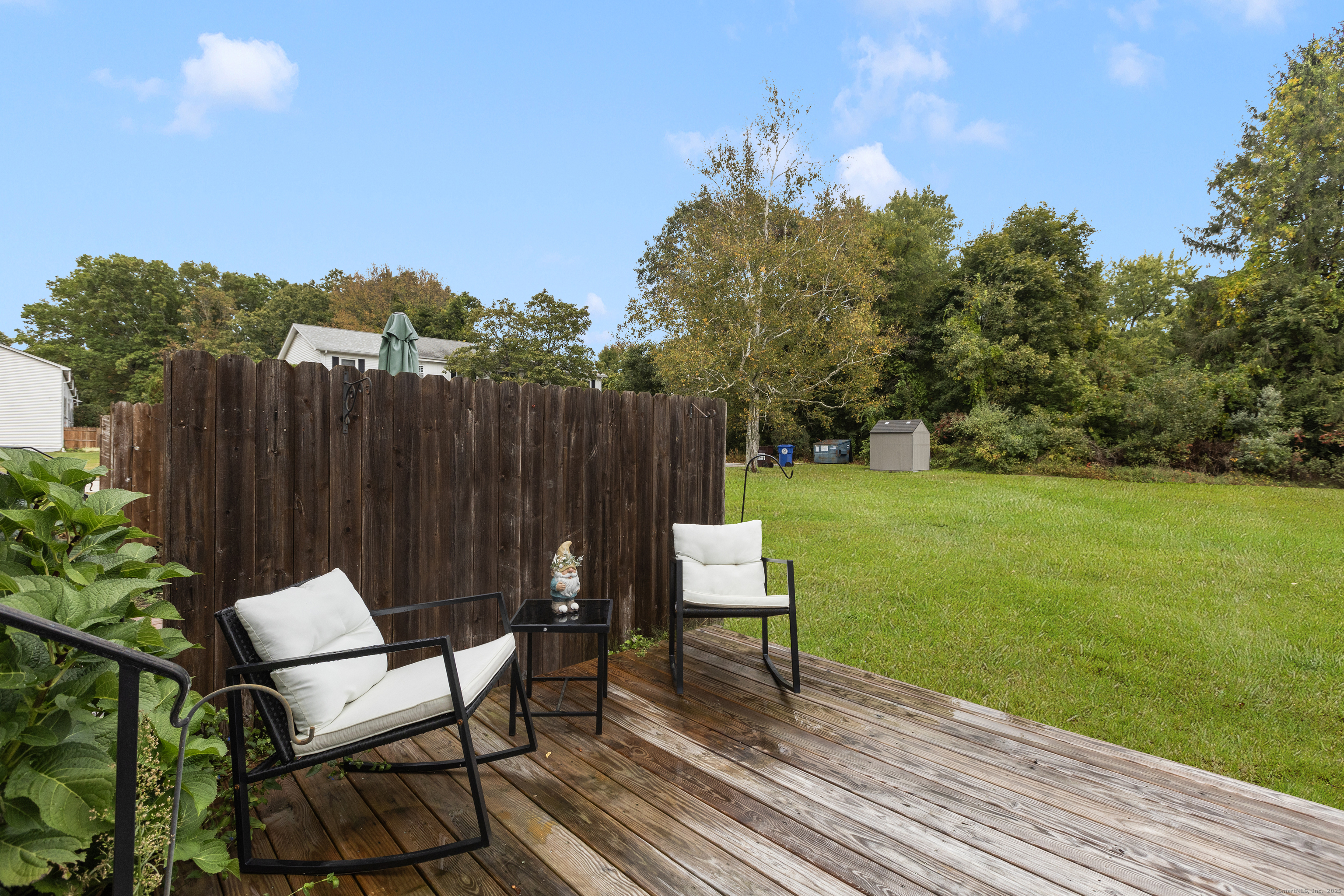 48 Athol Street, Unit 48 Killingly, CT 06239 - Photo 19 of 23 a view of a chair and table on the wooden floor