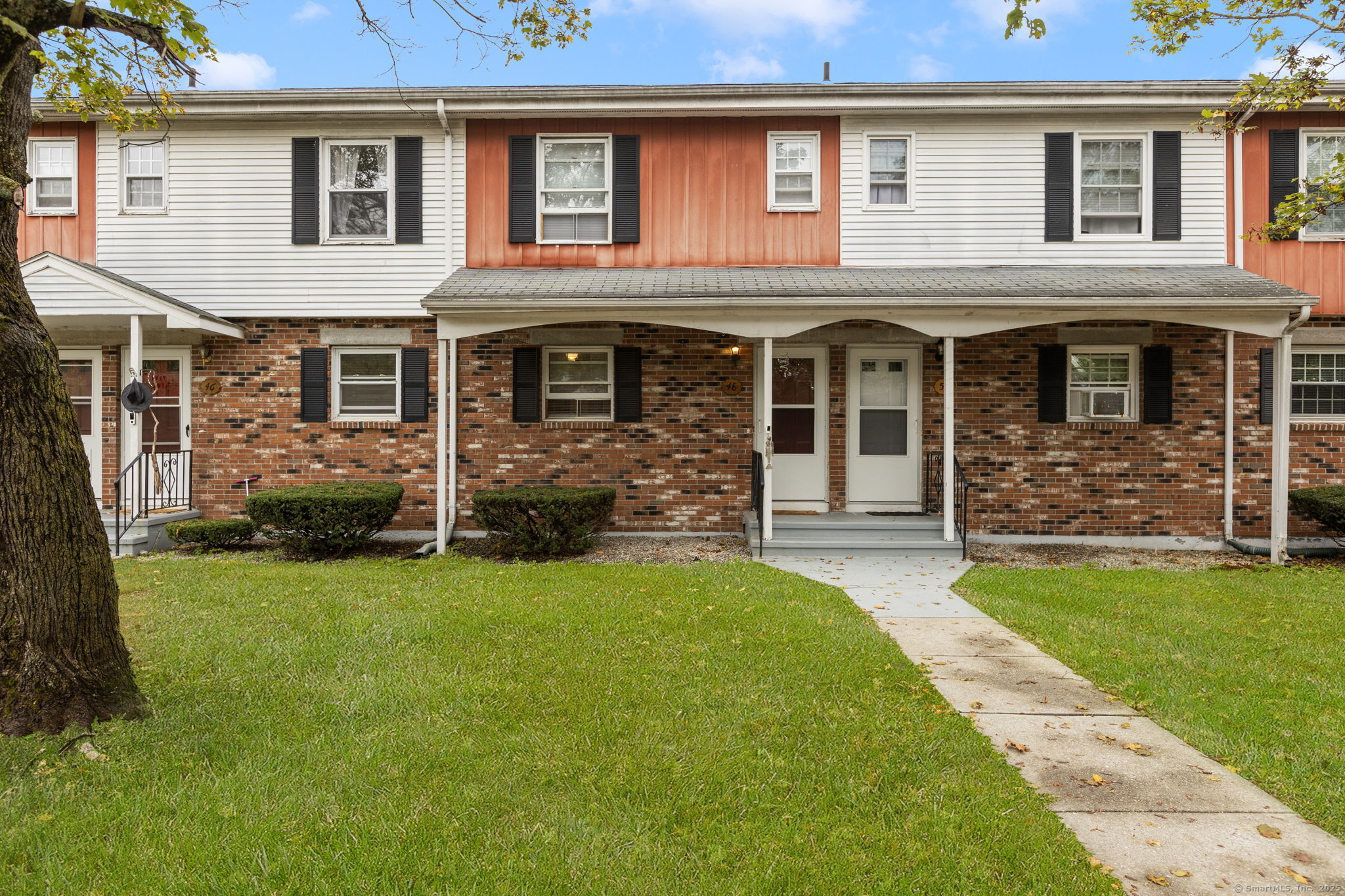 48 Athol Street, Unit 48 Killingly, CT 06239 - Photo 2 of 23 a front view of a house with a garden
