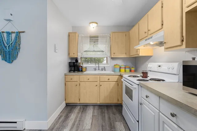 a kitchen with a sink cabinets and window