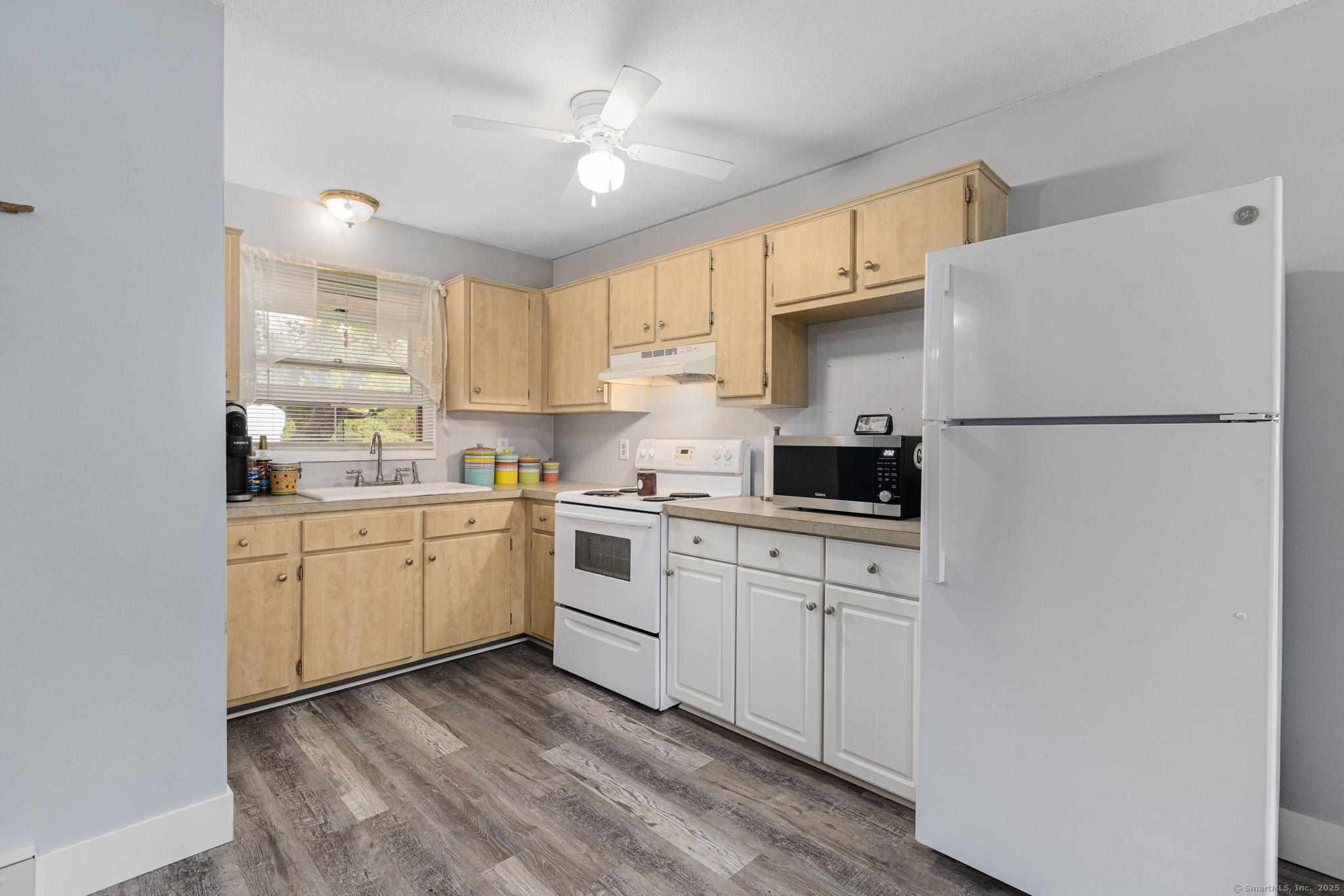 48 Athol Street, Unit 48 Killingly, CT 06239 - Photo 9 of 23 a kitchen with white cabinets and white appliances