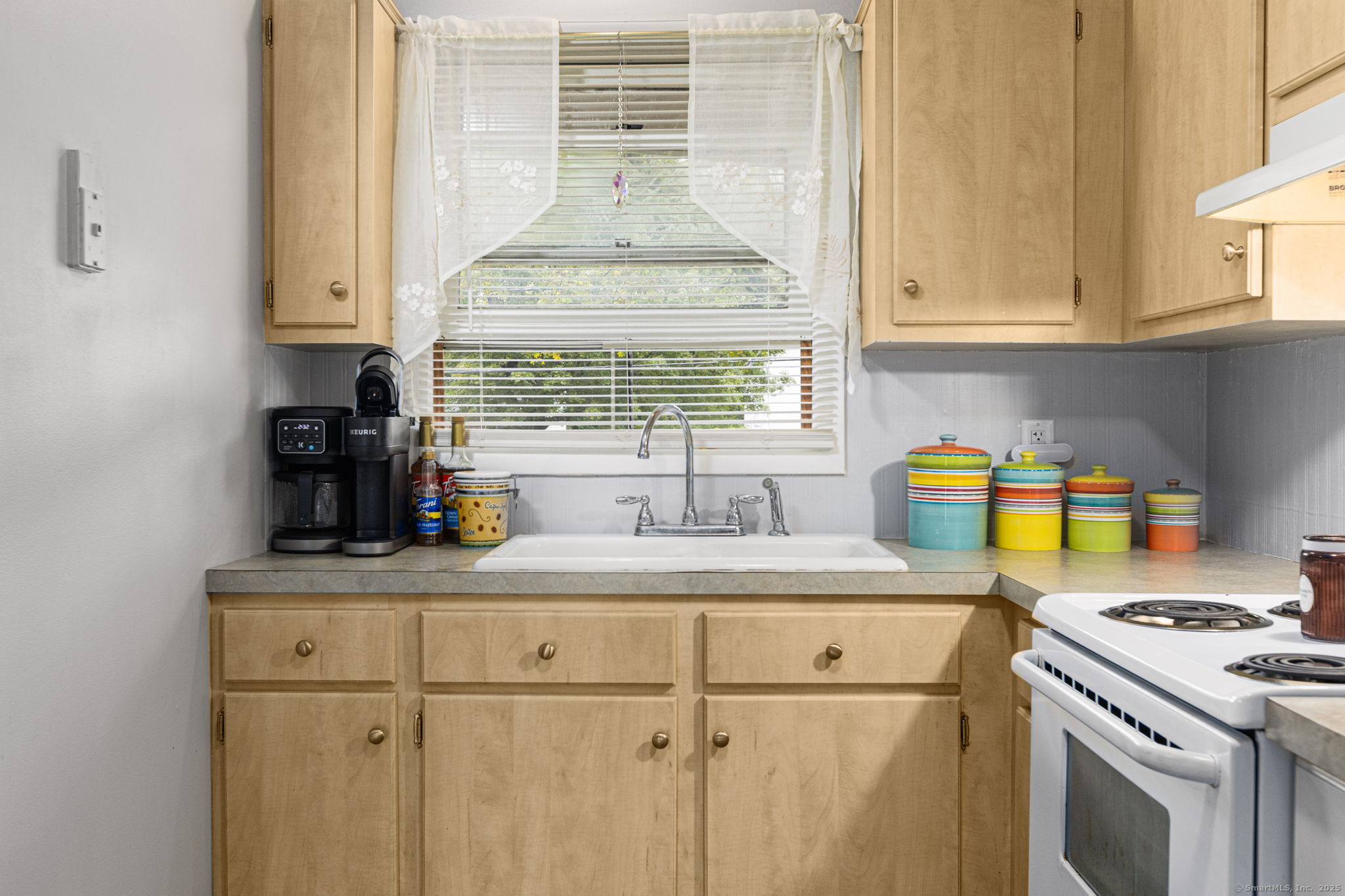48 Athol Street, Unit 48 Killingly, CT 06239 - Photo 10 of 23 a kitchen with kitchen island granite countertop a sink cabinets a window and stainless steel appliances