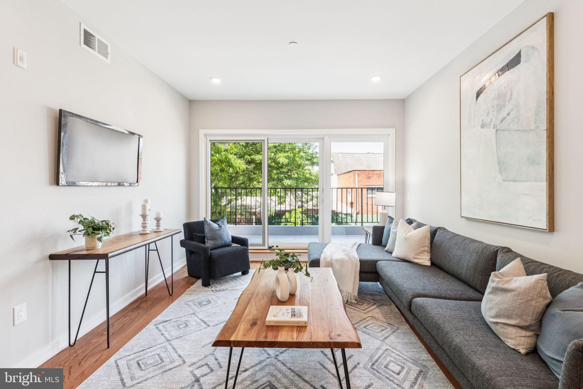 203 Haverford Avenue, Unit 208 Narberth, PA 19072 - Photo 11 of 35 a living room with furniture and a large window