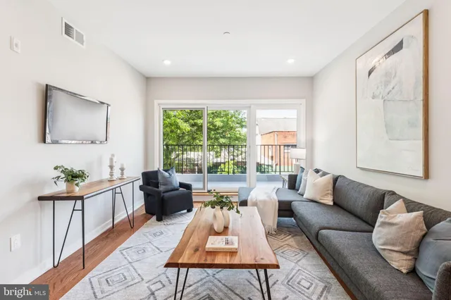 a living room with furniture and a large window