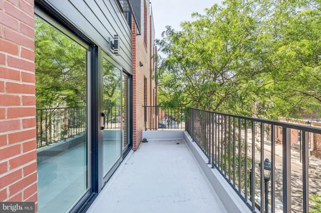 a view of a balcony with wooden floor
