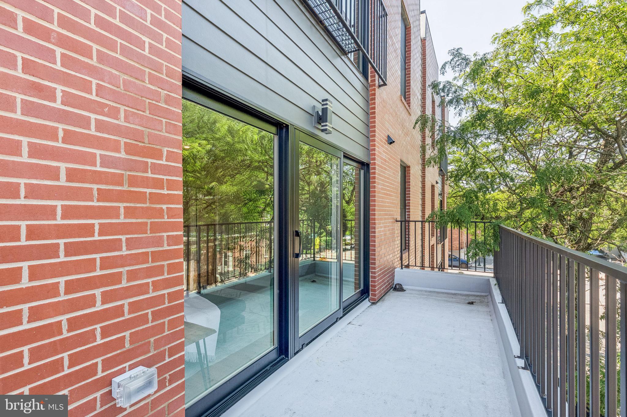 203 Haverford Avenue, Unit 208 Narberth, PA 19072 - Photo 16 of 35 a view of a brick house with a large window