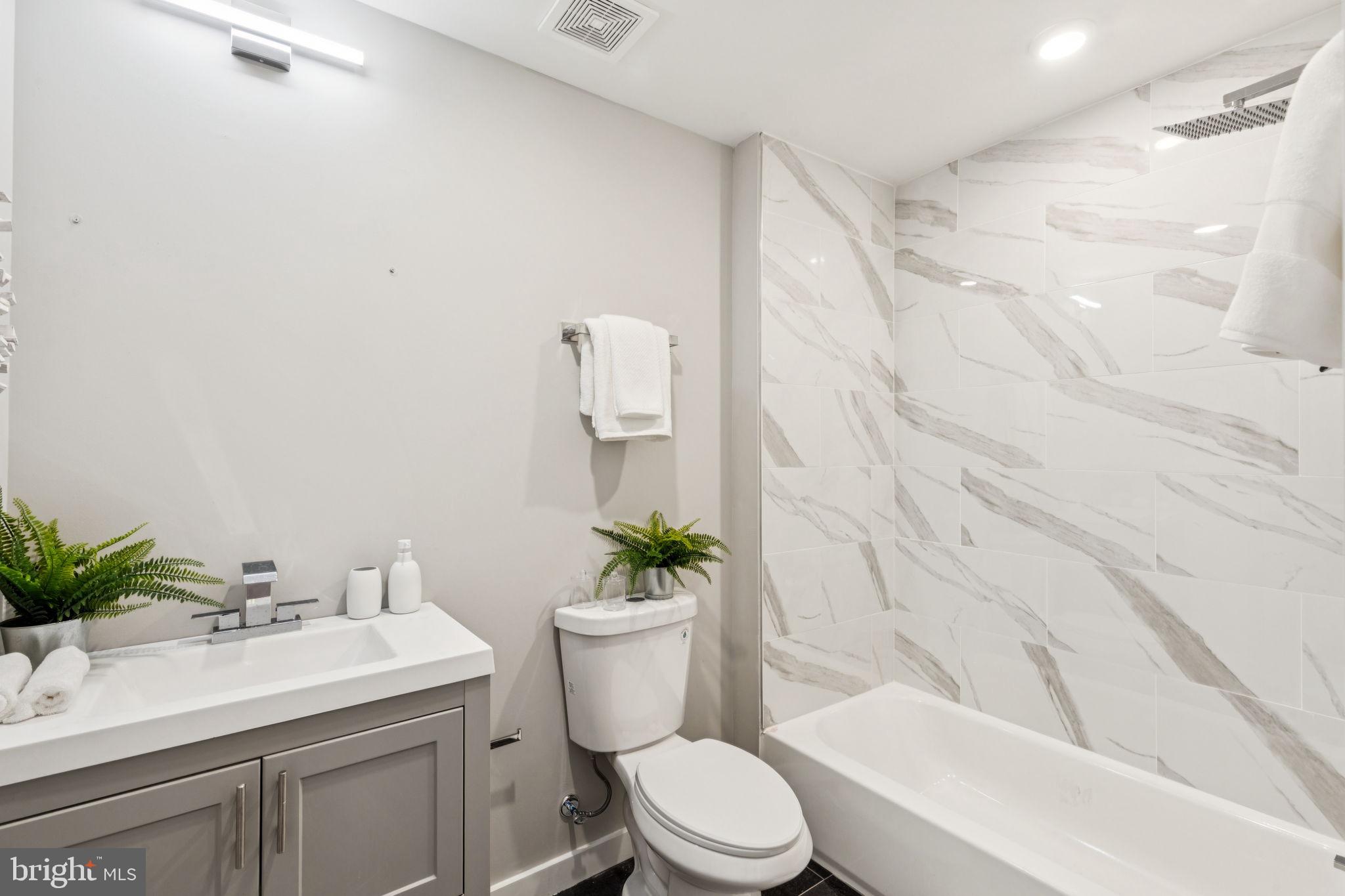 203 Haverford Avenue, Unit 208 Narberth, PA 19072 - Photo 22 of 35 a bathroom with a sink a toilet a tub and shower