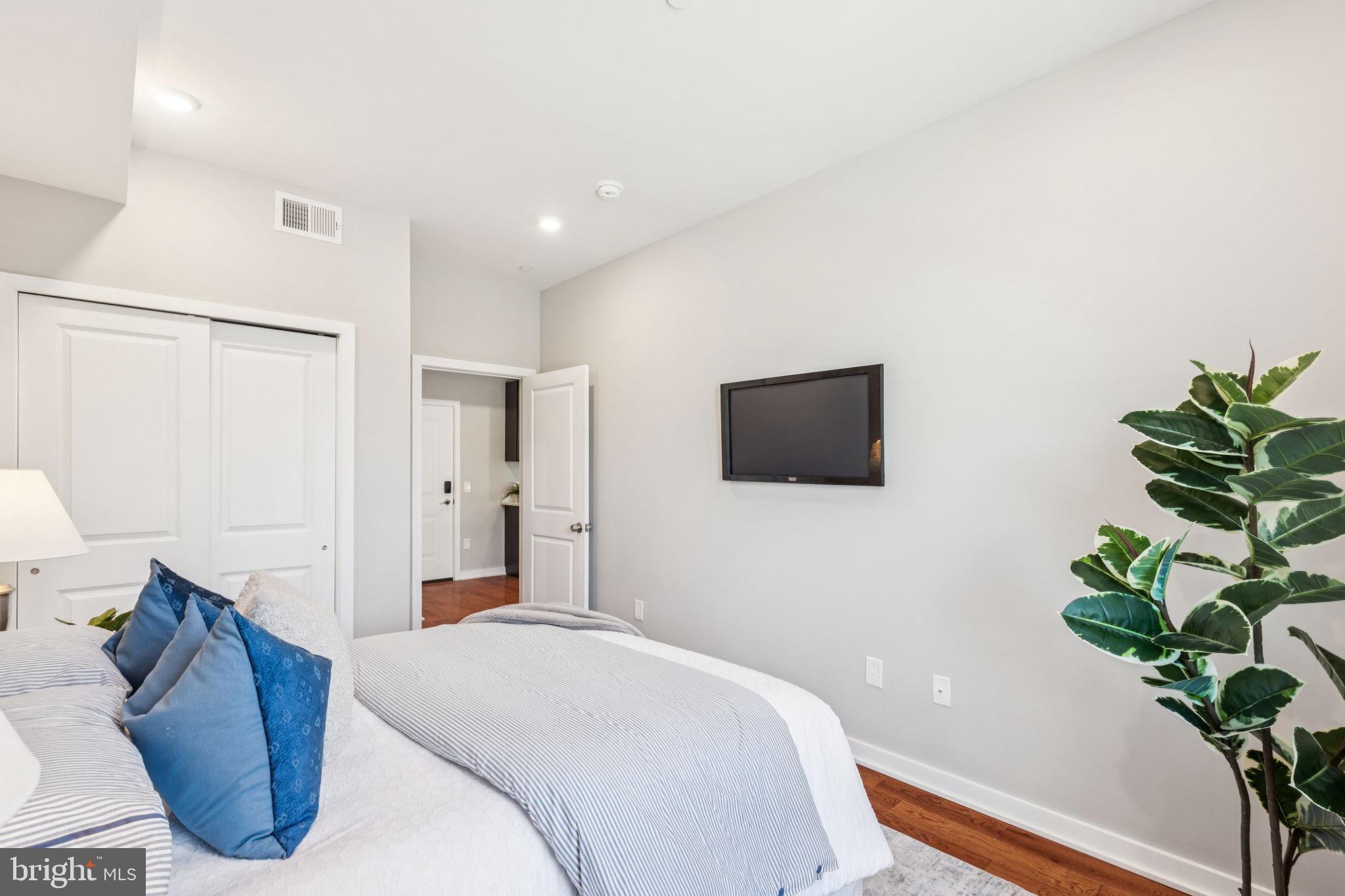 203 Haverford Avenue, Unit 208 Narberth, PA 19072 - Photo 25 of 35 a bedroom with a bed and a potted plant
