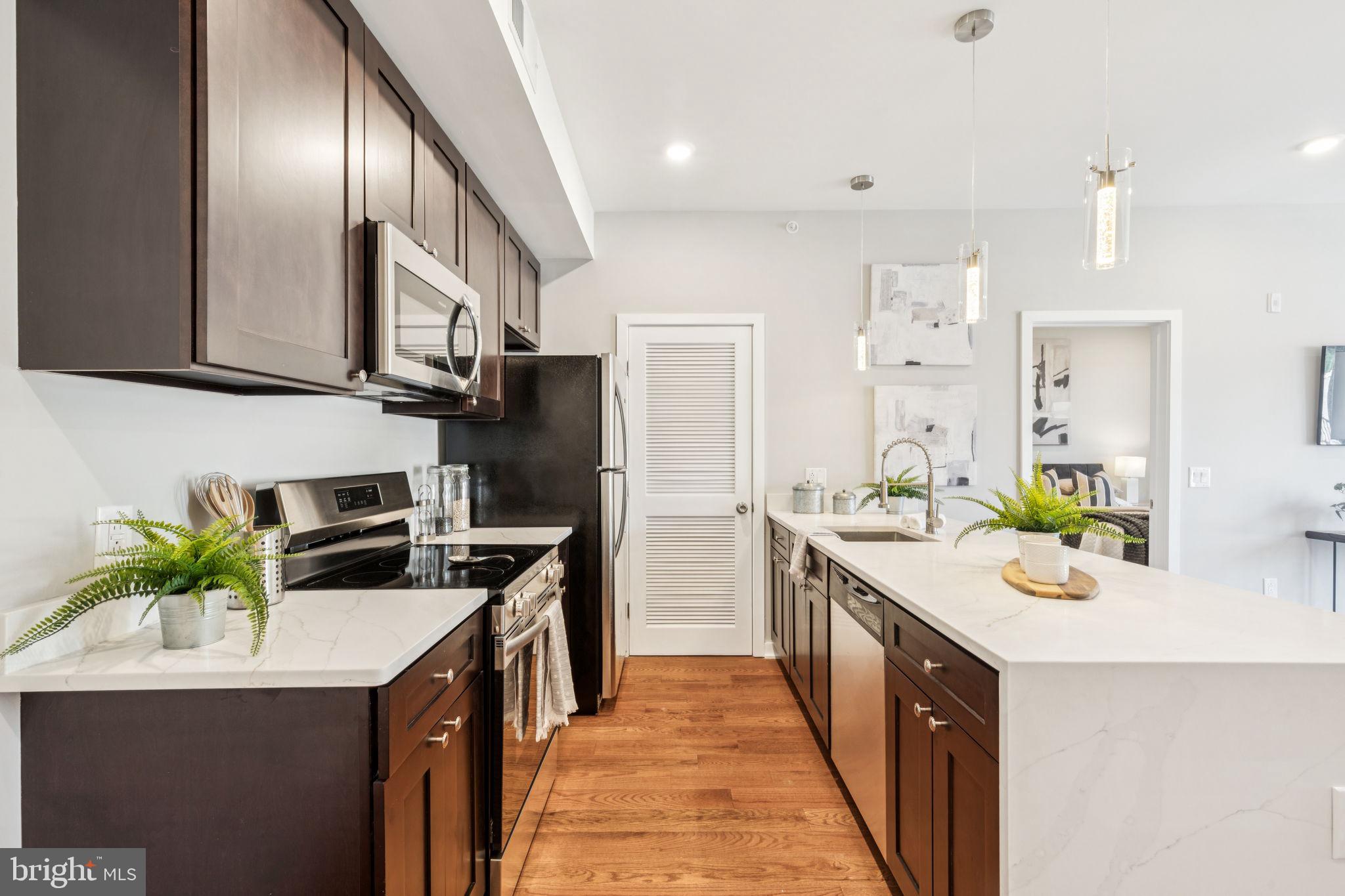 203 Haverford Avenue, Unit 208 Narberth, PA 19072 - Photo 5 of 35 a kitchen with a sink stove and refrigerator