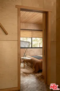 a bedroom with a bed and large window