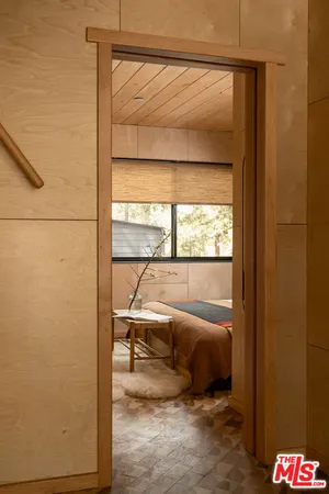 a bedroom with a bed and large window