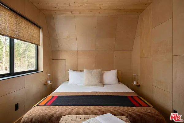 a room with a bed and window