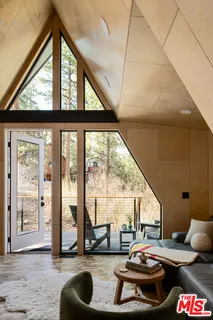 a living room with furniture and a floor to ceiling window