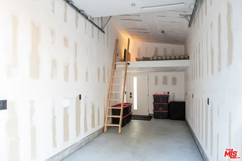 a view of front door with furniture and a window