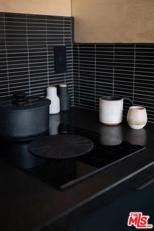 a bathroom with a granite countertop toilet and a sink
