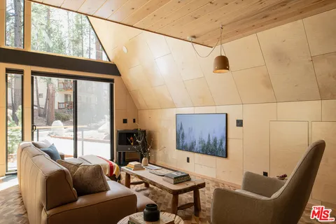 a living room with furniture and a floor to ceiling window