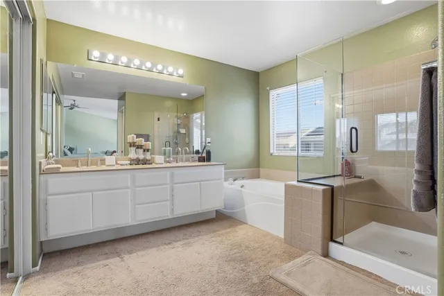 a bedroom with a bed window and a flat screen tv