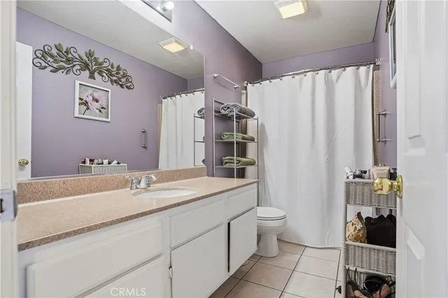 a view of a room with a ceiling fan and window