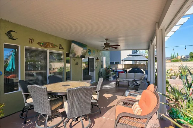 a view of a patio with a table and chairs under an umbrella