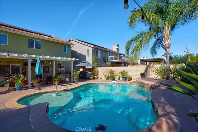 a view of a backyard with plants and a patio