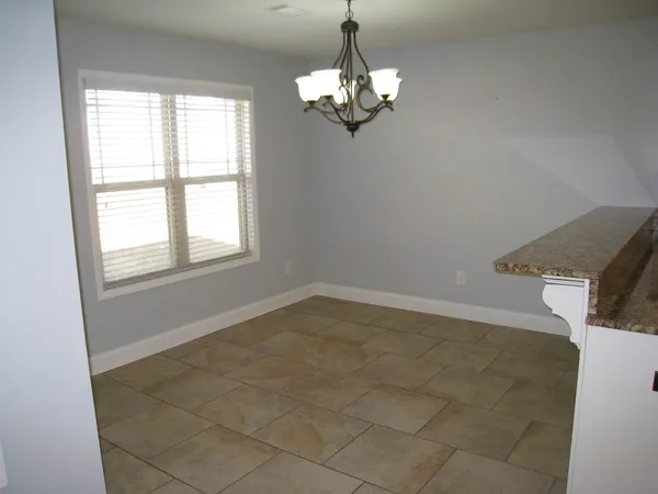a kitchen with kitchen island a counter top space and cabinetry