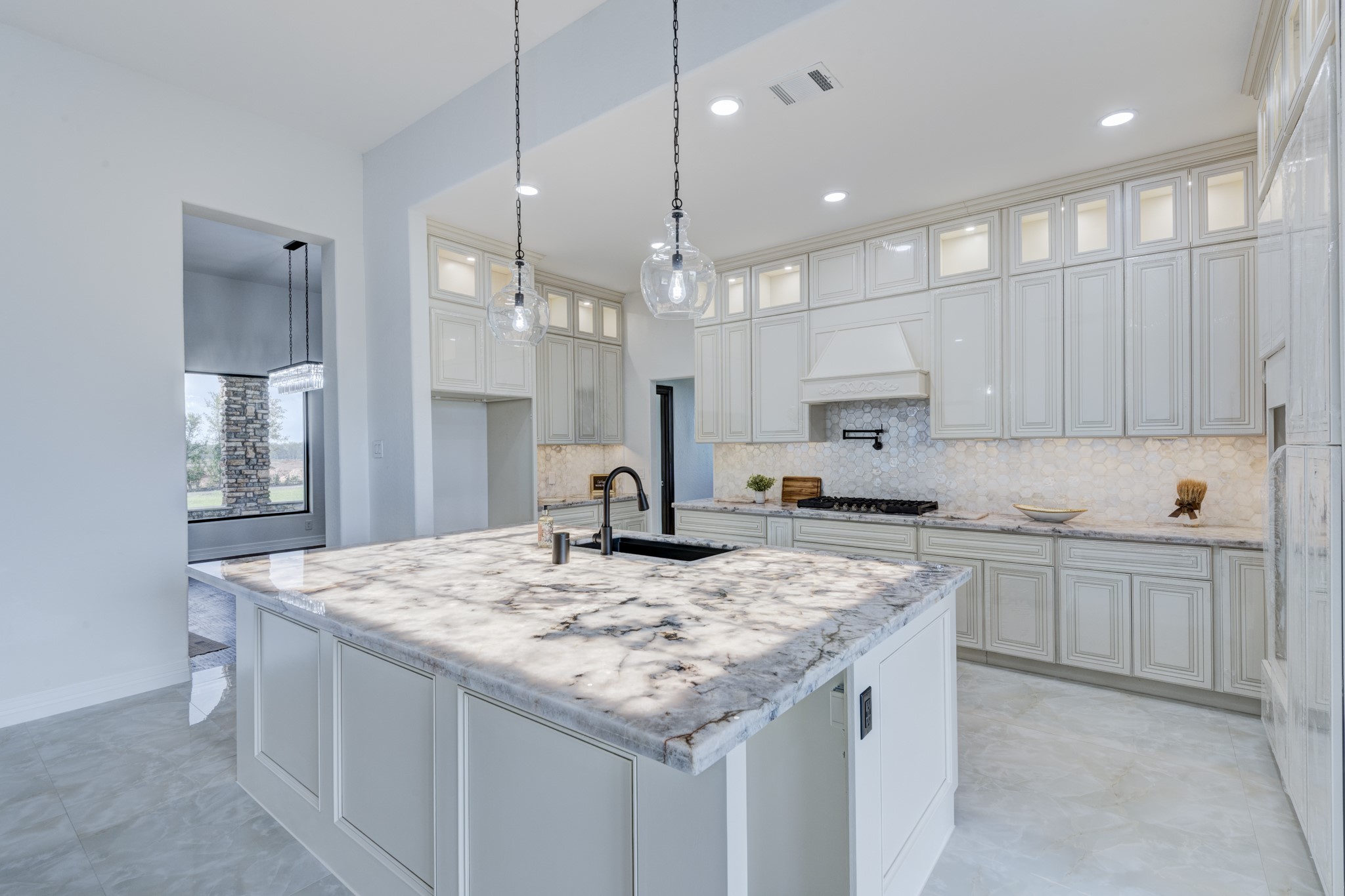 7348 Love Road Fulshear, TX 77441 - Photo 9 of 48 The stunning island with under-counter lighting creates a perfect space for entertaining.