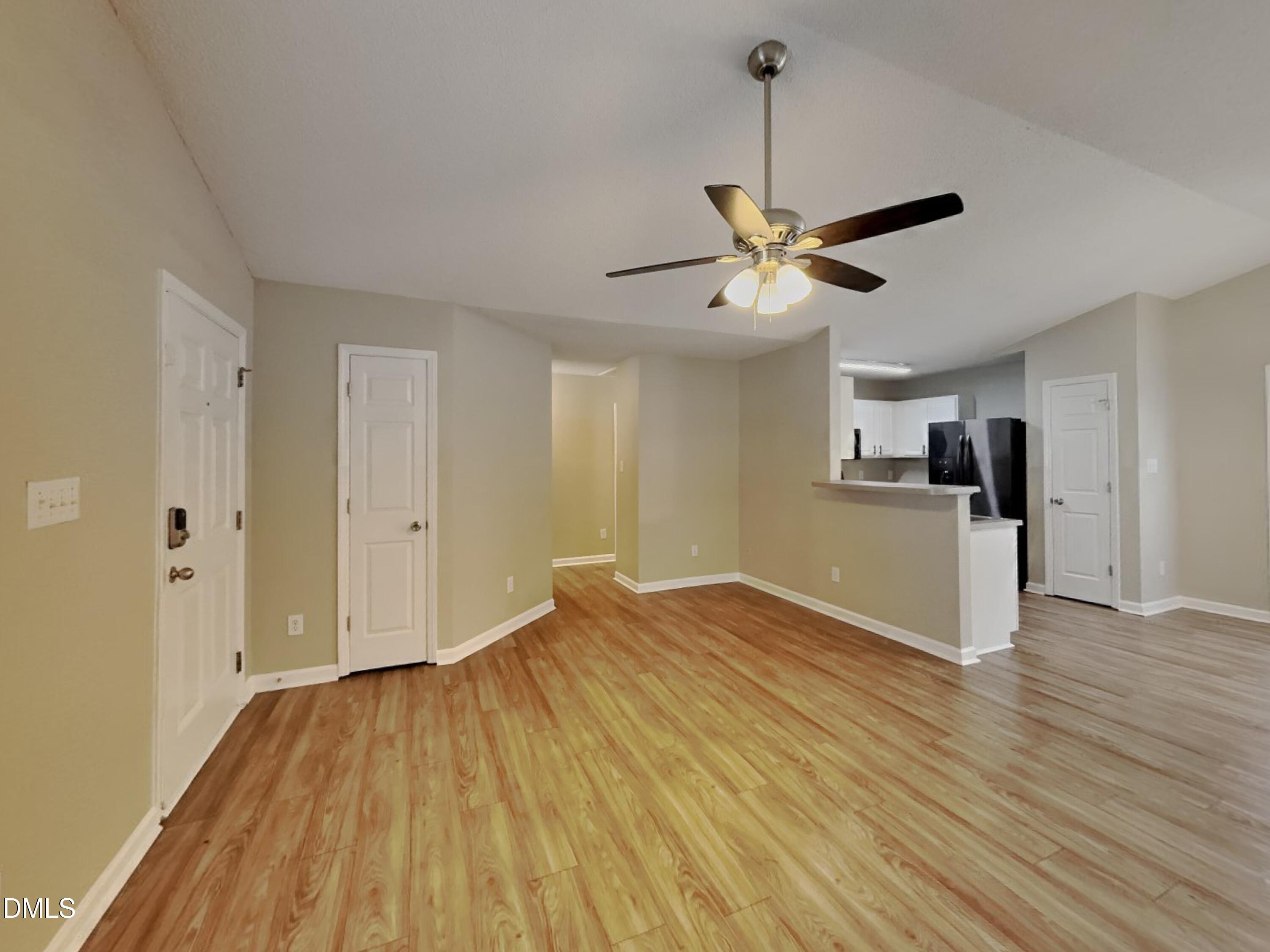 5516 Wilhagan Court Raleigh, NC 27616 - Photo 3 of 16 a view of a kitchen with wooden floor and a ceiling fan