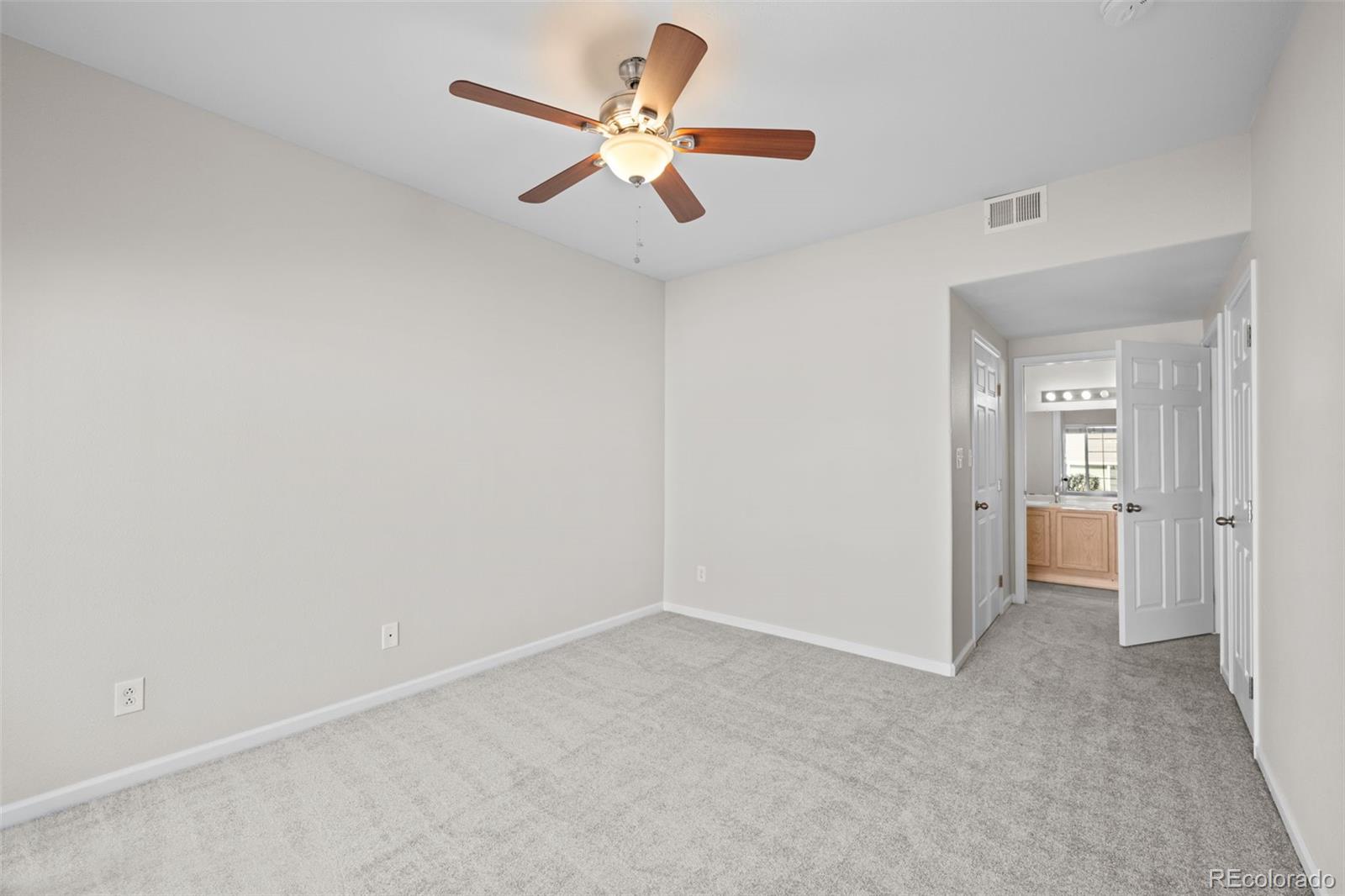 8389 Pebble Creek Way, Unit 101 Highlands Ranch, CO 80126 - Photo 15 of 44 a view of a livingroom with a ceiling fan