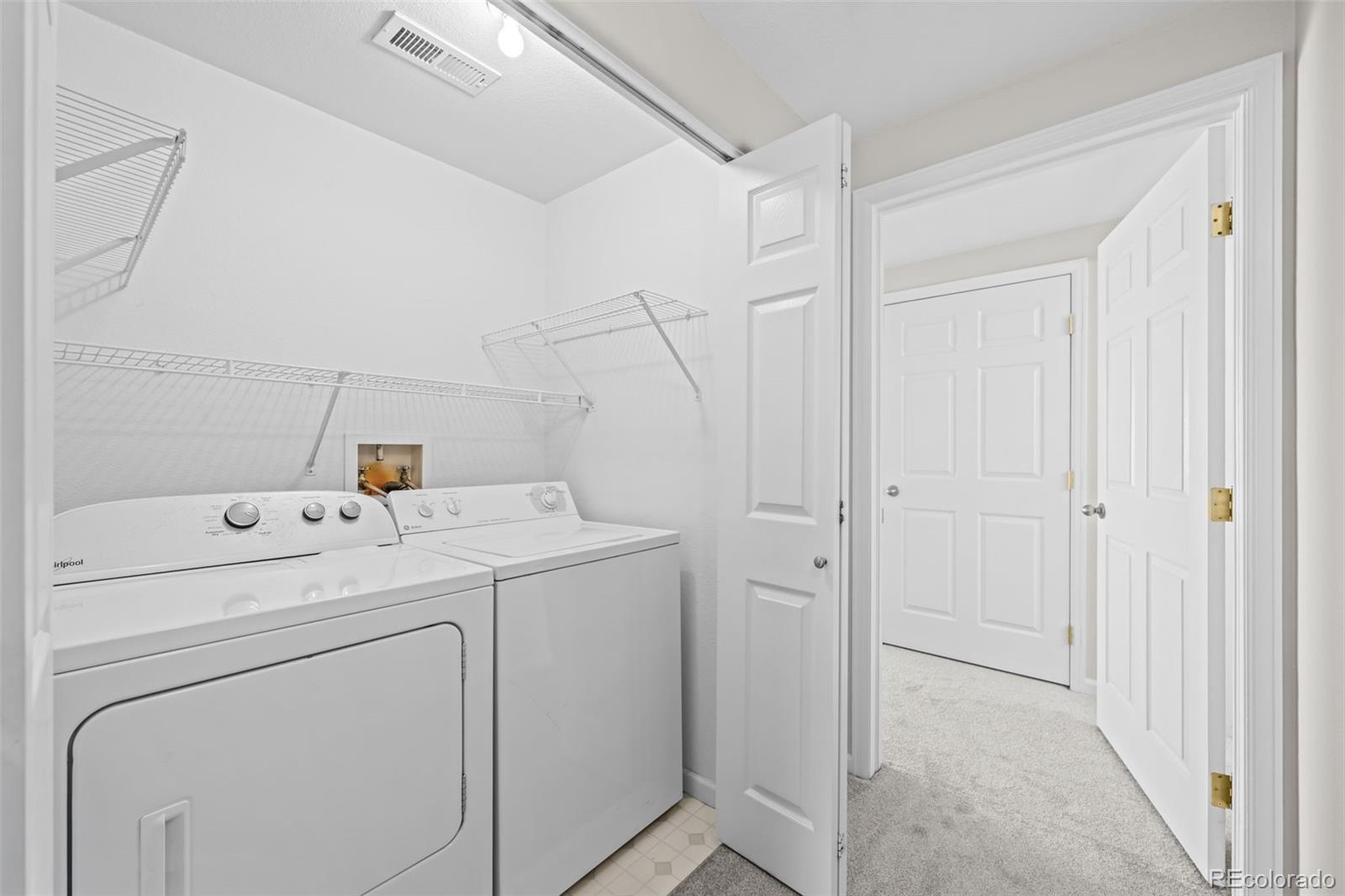 8389 Pebble Creek Way, Unit 101 Highlands Ranch, CO 80126 - Photo 18 of 44 a view of storage and utility room with washer and dryer