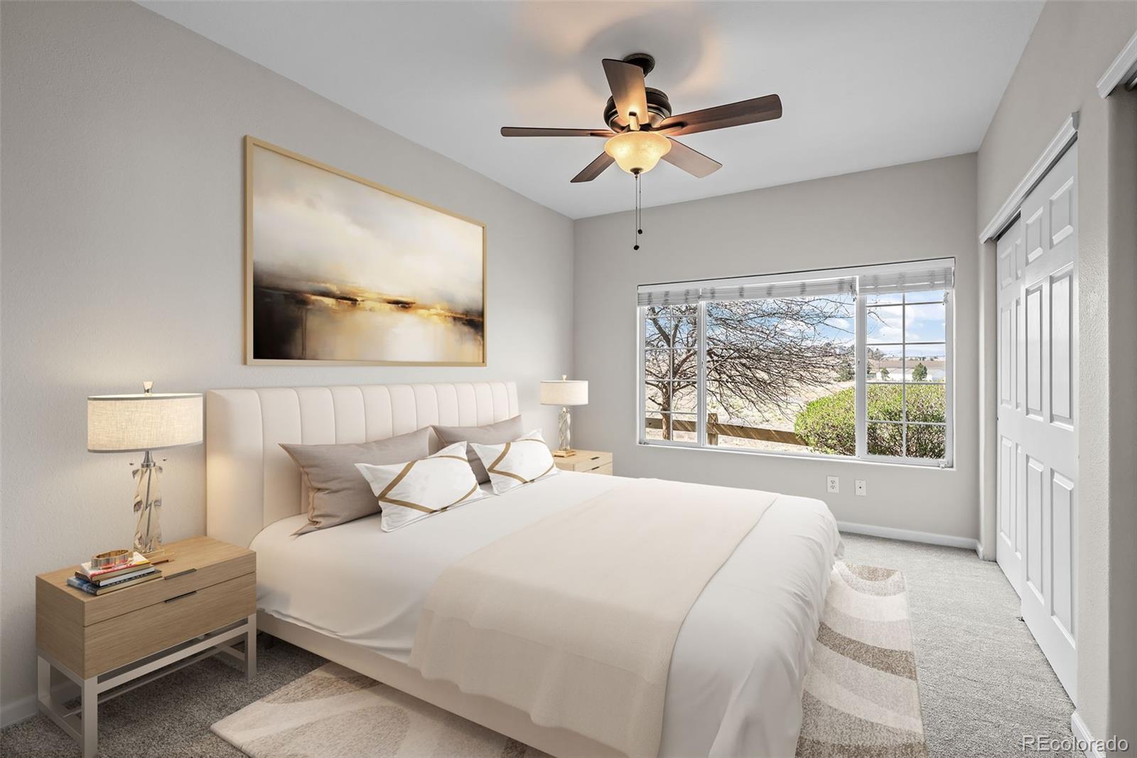 8389 Pebble Creek Way, Unit 101 Highlands Ranch, CO 80126 - Photo 19 of 44 a bedroom with a large bed and a window