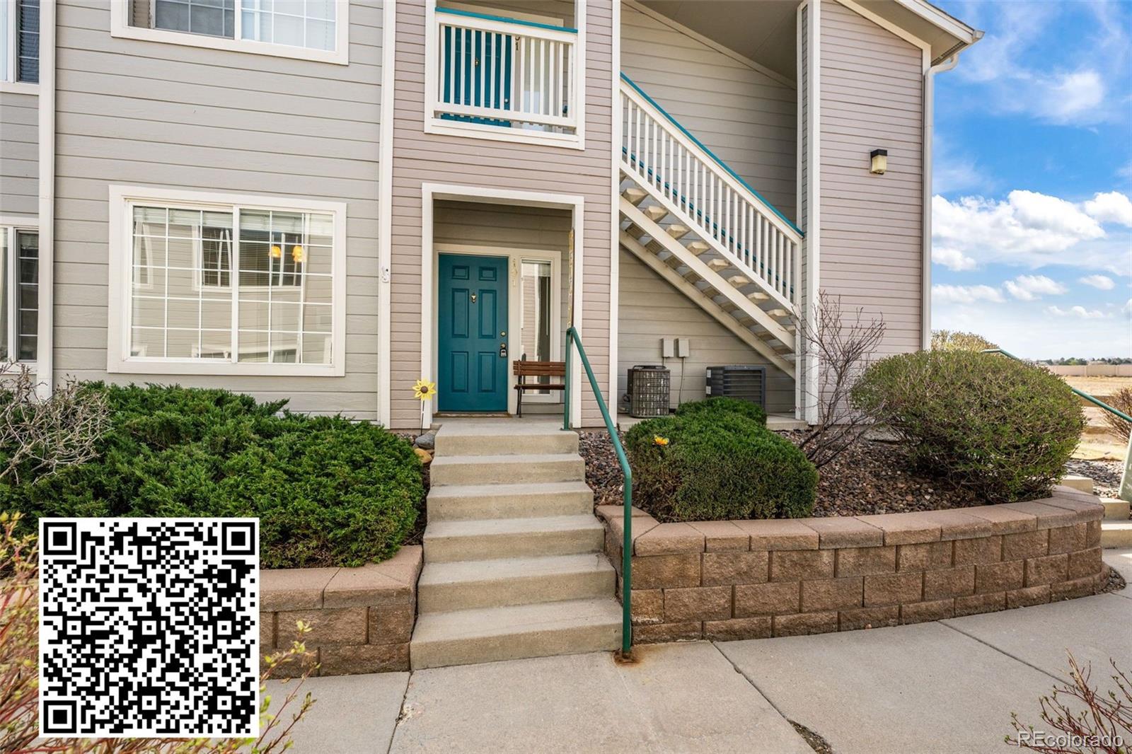 8389 Pebble Creek Way, Unit 101 Highlands Ranch, CO 80126 - Photo 2 of 44 a front view of a house with plants