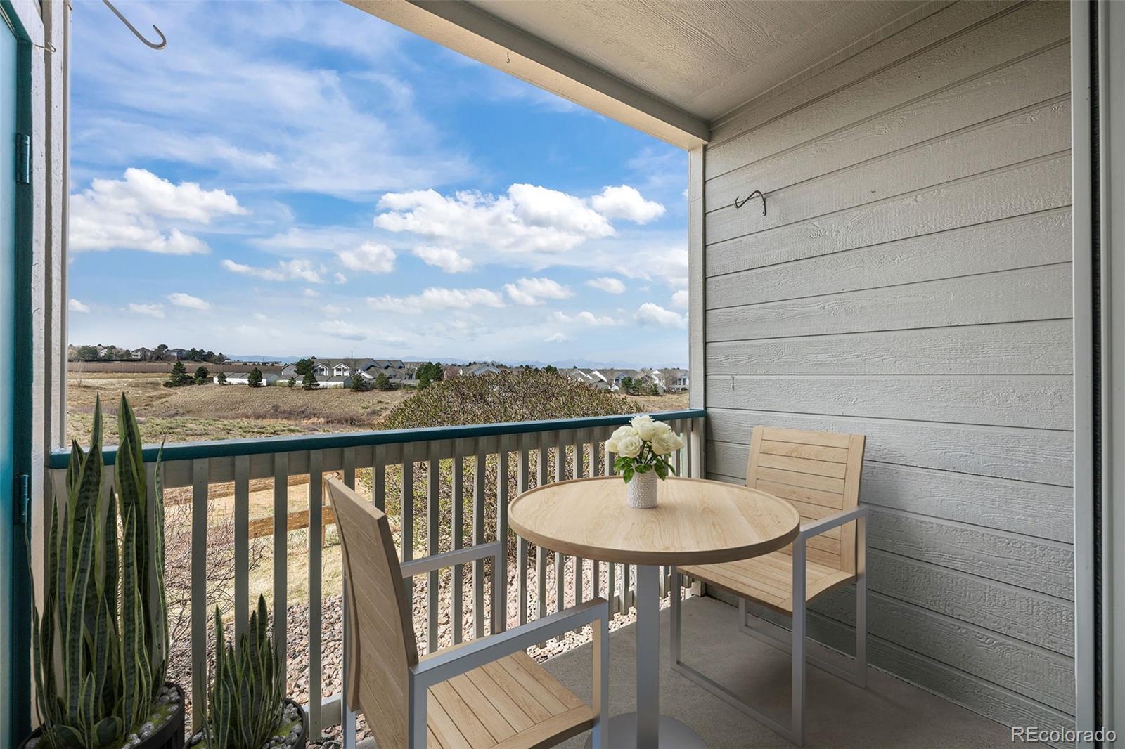 8389 Pebble Creek Way, Unit 101 Highlands Ranch, CO 80126 - Photo 23 of 44 a balcony with table and chairs