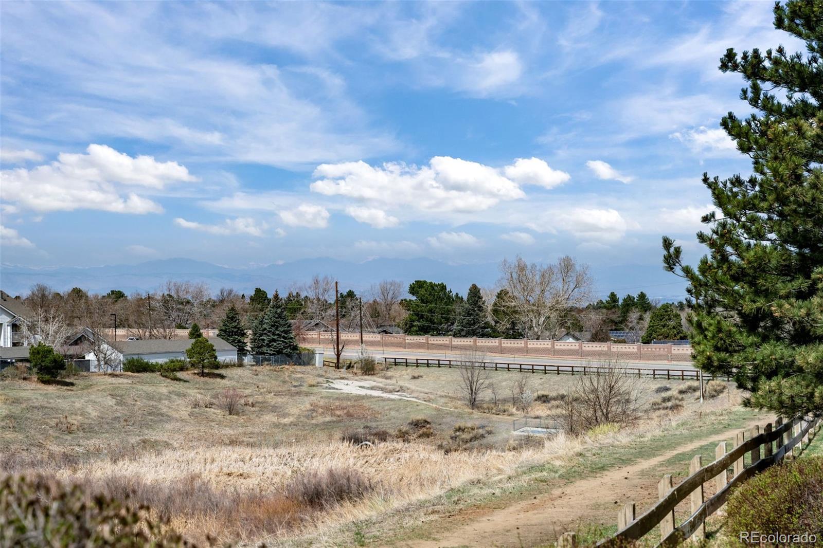 8389 Pebble Creek Way, Unit 101 Highlands Ranch, CO 80126 - Photo 34 of 44 a view of a dry yard with wooden fence