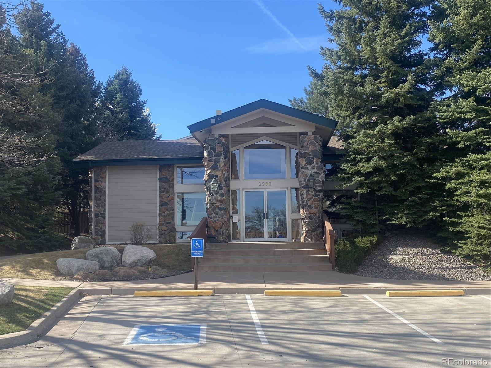 8389 Pebble Creek Way, Unit 101 Highlands Ranch, CO 80126 - Photo 36 of 44 a front view of a house with a yard