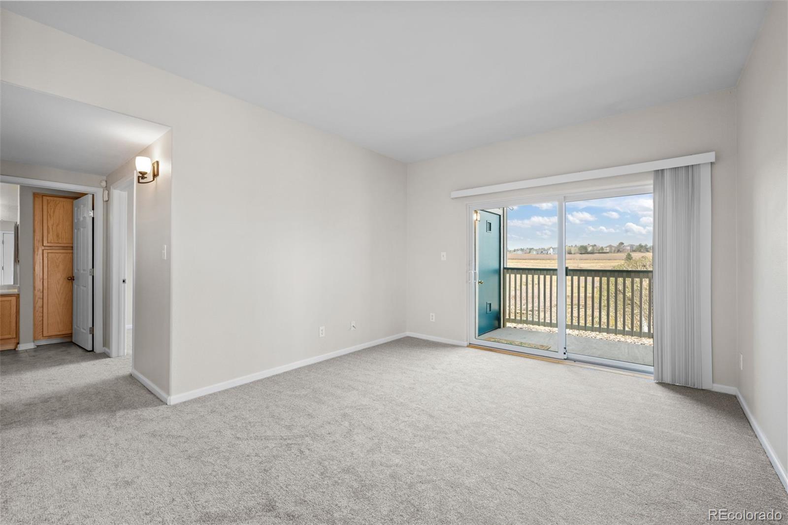 8389 Pebble Creek Way, Unit 101 Highlands Ranch, CO 80126 - Photo 4 of 44 an empty room with windows
