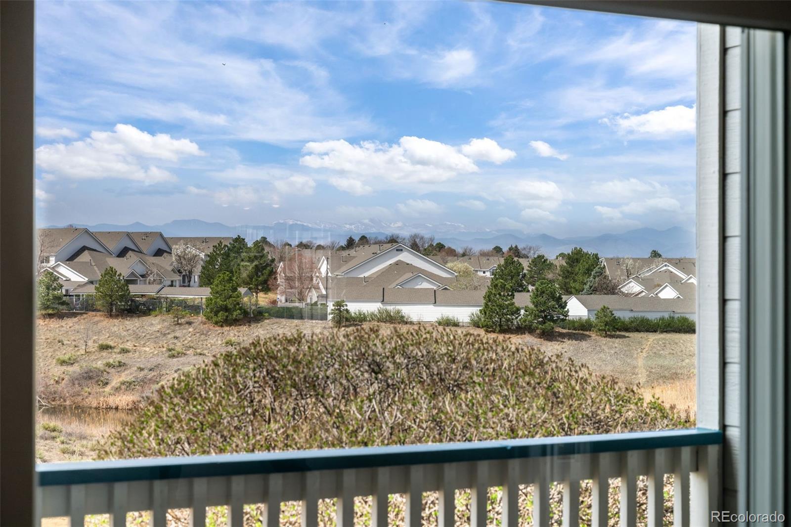 8389 Pebble Creek Way, Unit 101 Highlands Ranch, CO 80126 - Photo 5 of 44 a view of a lake from a balcony