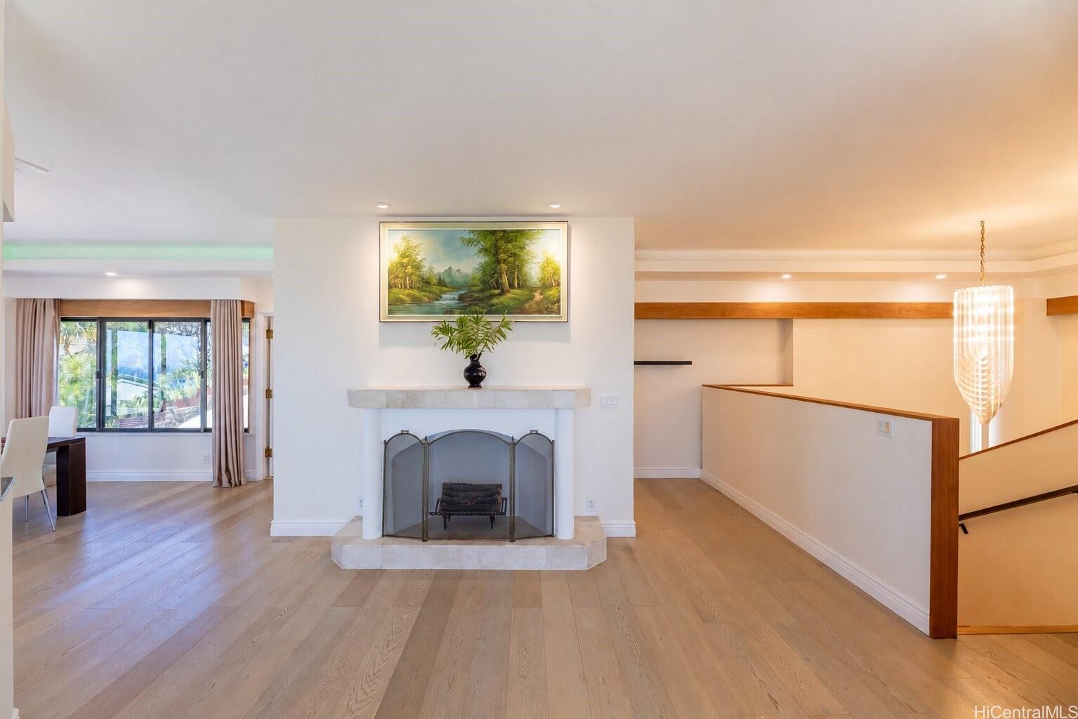 1632 Ihiloa Loop Honolulu, HI 96821 - Photo 5 of 24 a hallway with a fireplace and a chandelier