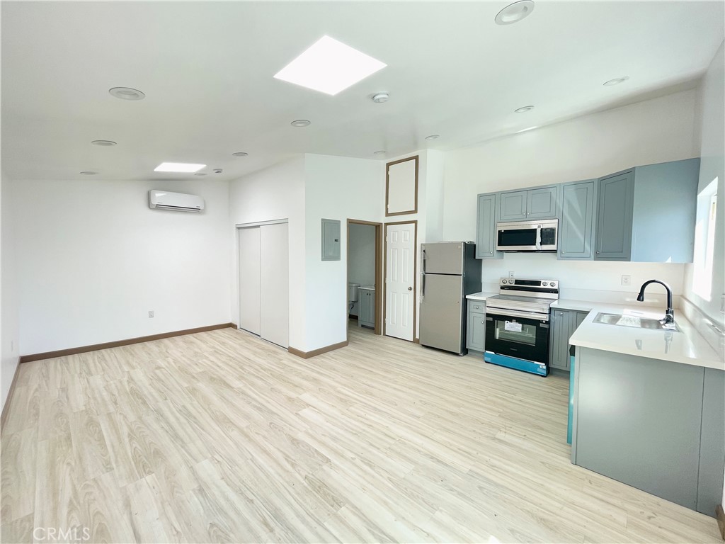 a kitchen with stainless steel appliances a refrigerator sink and stove